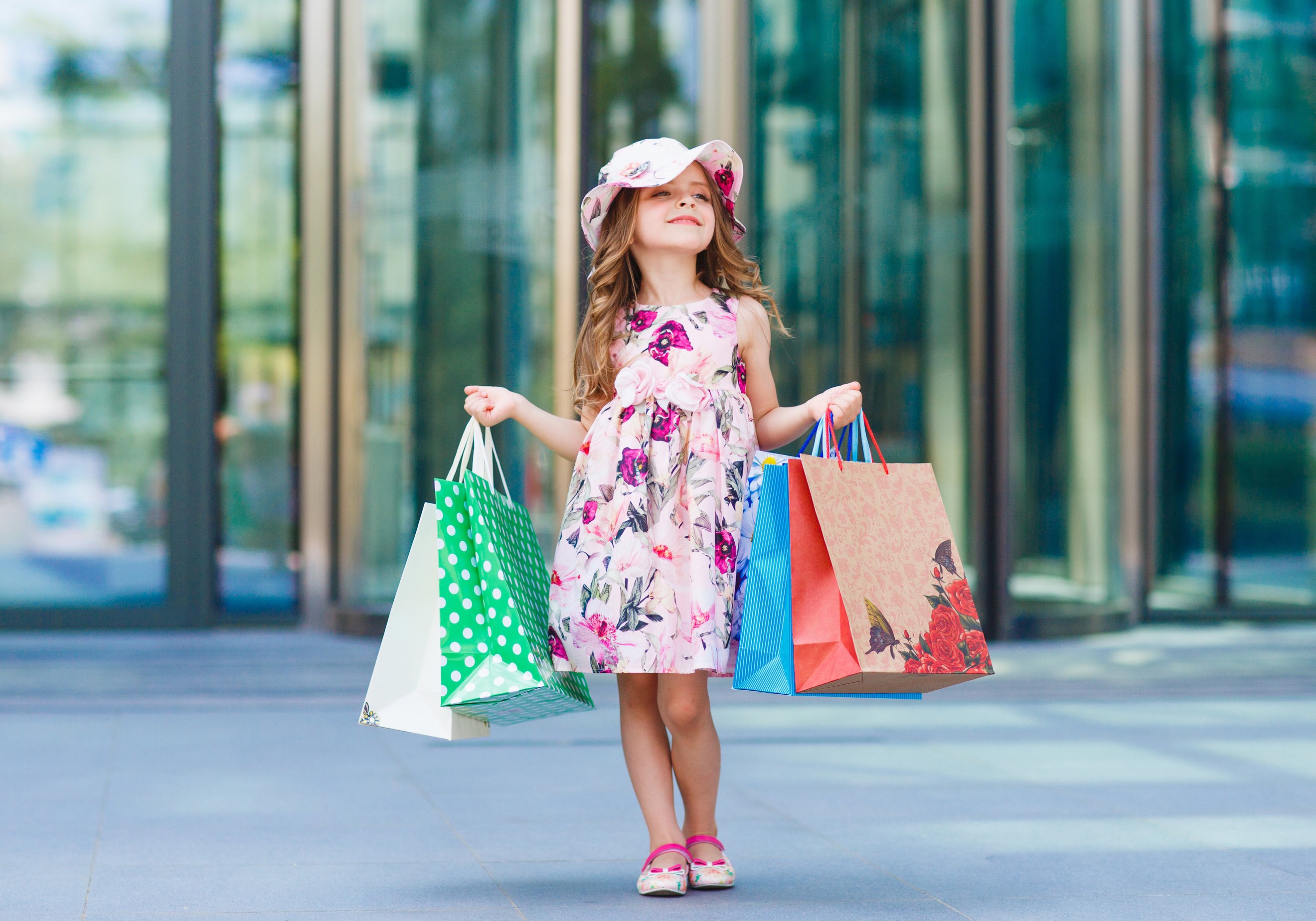 Cute little girl on shopping. Portrait of a kid with shopping bags. Shopping. girl.